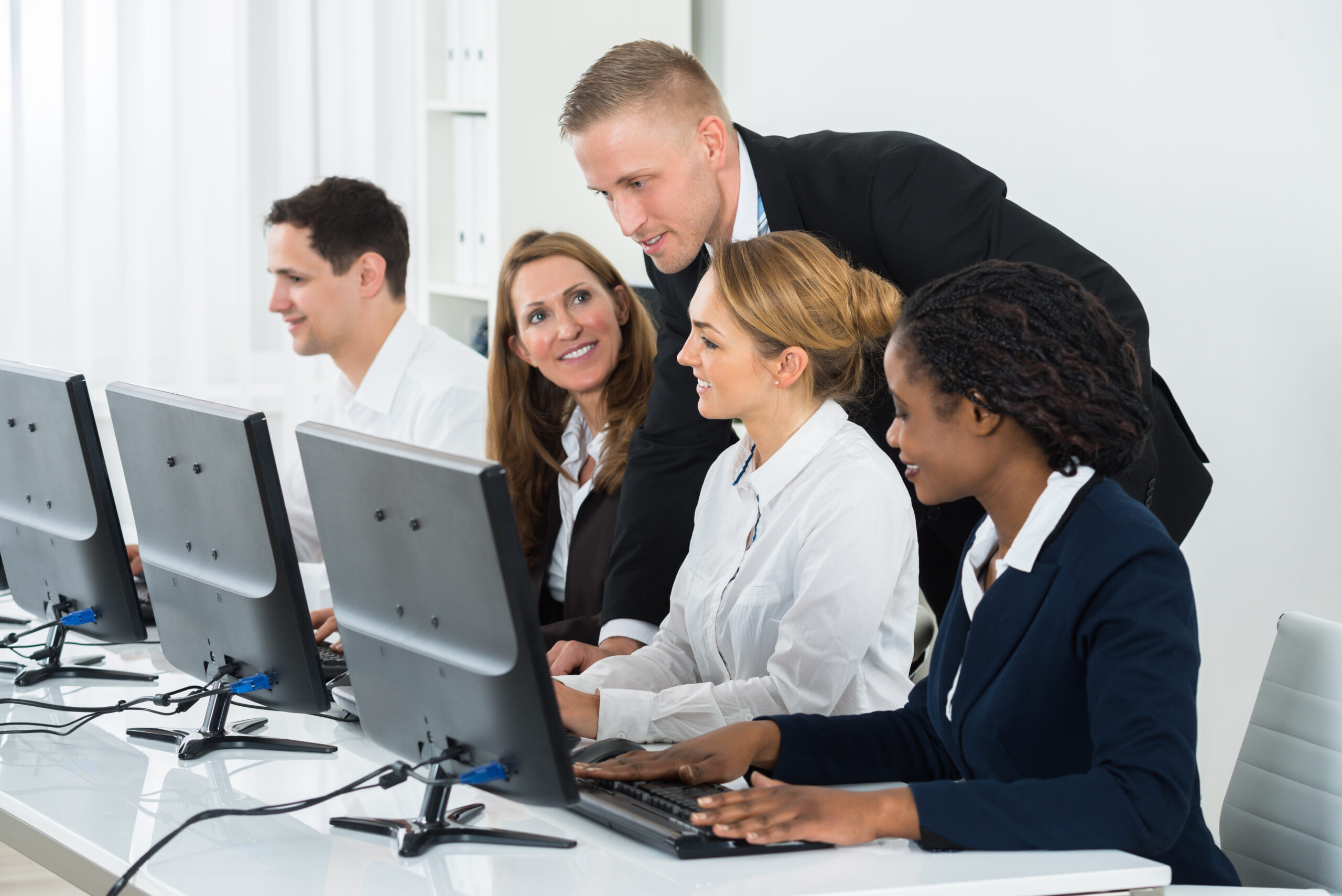 Businessman Helping His Colleagues In The Office